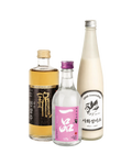 Three Korean liquor bottles arranged together on a plain white background: a taller bottle with amber liquid and a black label on the left, a small clear bottle with a pink label in the center, and a tall cream-colored bottle with a silver cap on the right.