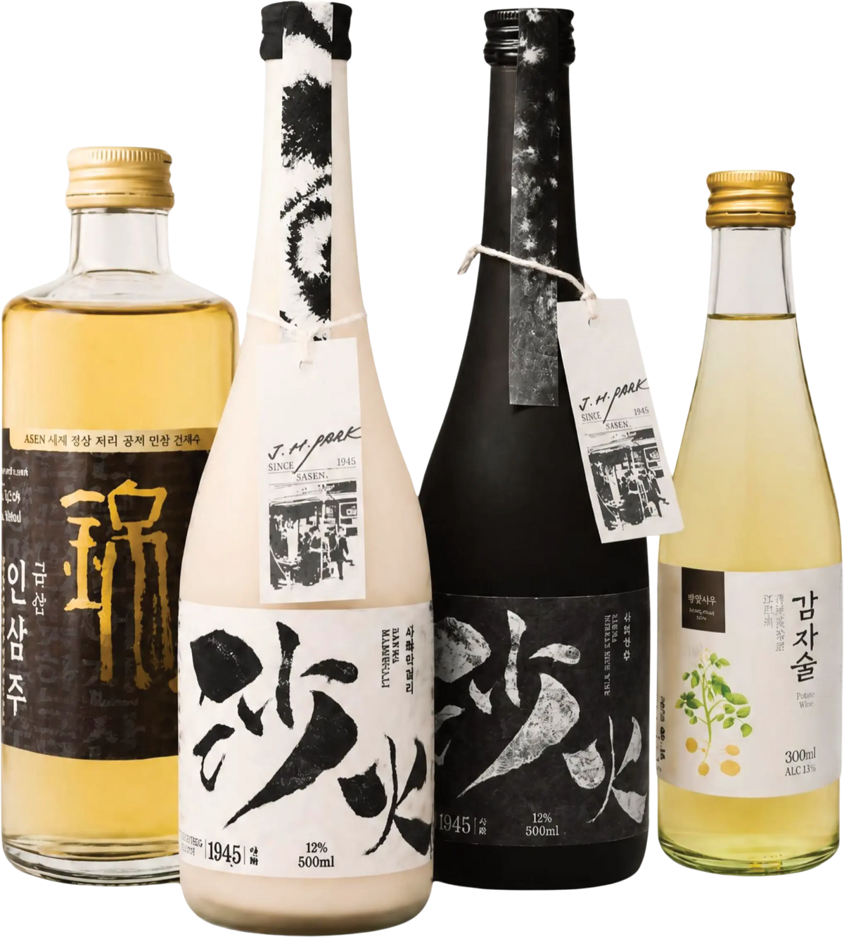 Four Korean liquor bottles arranged together on a white background: a clear glass bottle with pale golden liquid and gold cap on the left, a tall off-white bottle with black calligraphy label and white hangtag, a tall matte black bottle with black calligraphy label and white hangtag, and a small clear bottle with pale yellow liquid, green label, and gold cap on the right.