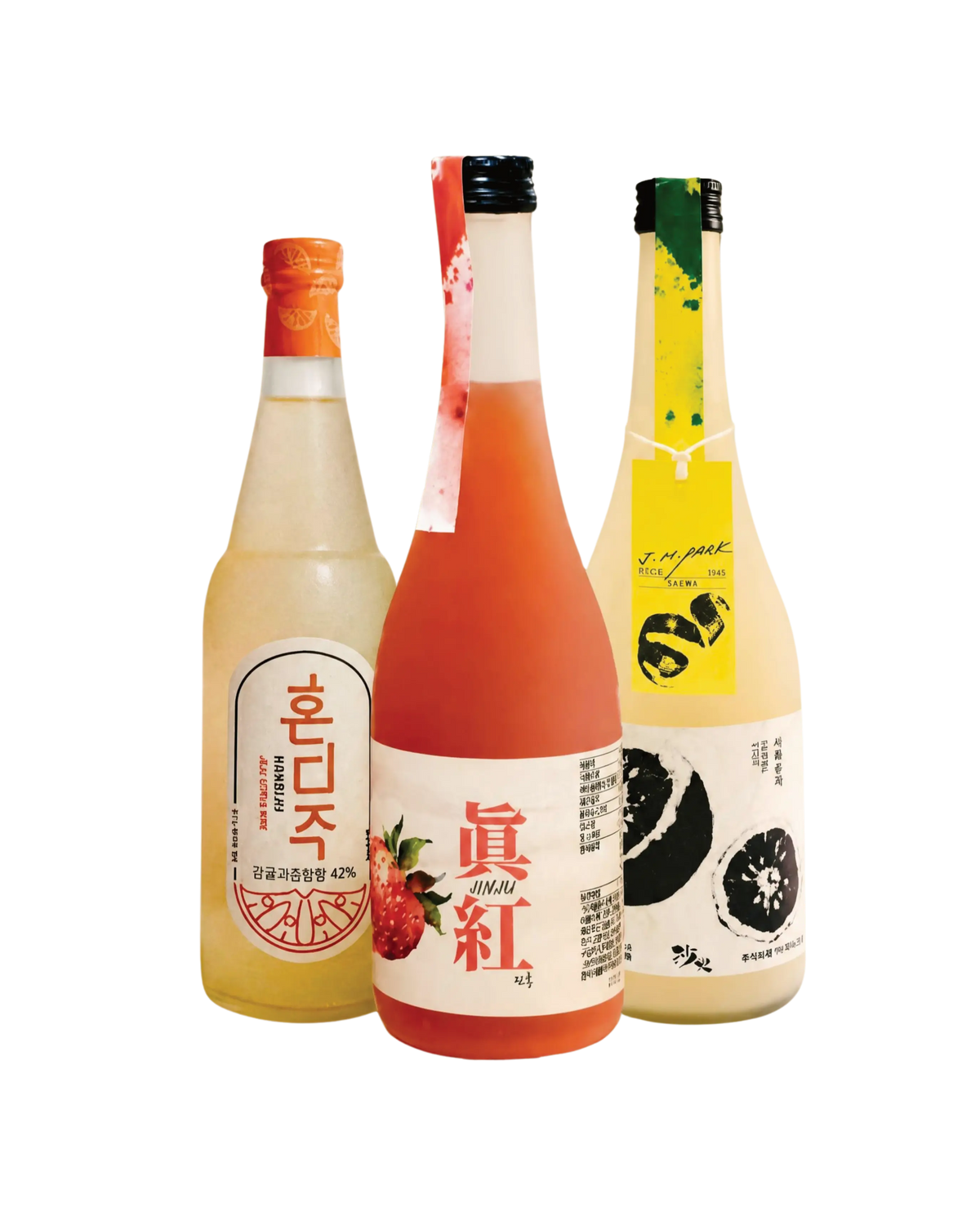 Three bottles of Korean liquor arranged side by side on a plain white background. The left bottle has a light golden-amber liquid and an orange label with Korean text; the center bottle has a pink-red liquid and a white label with red text and fruit imagery; the right bottle has a pale yellow-amber liquid, a black cap, and a yellow label with black fruit illustrations.